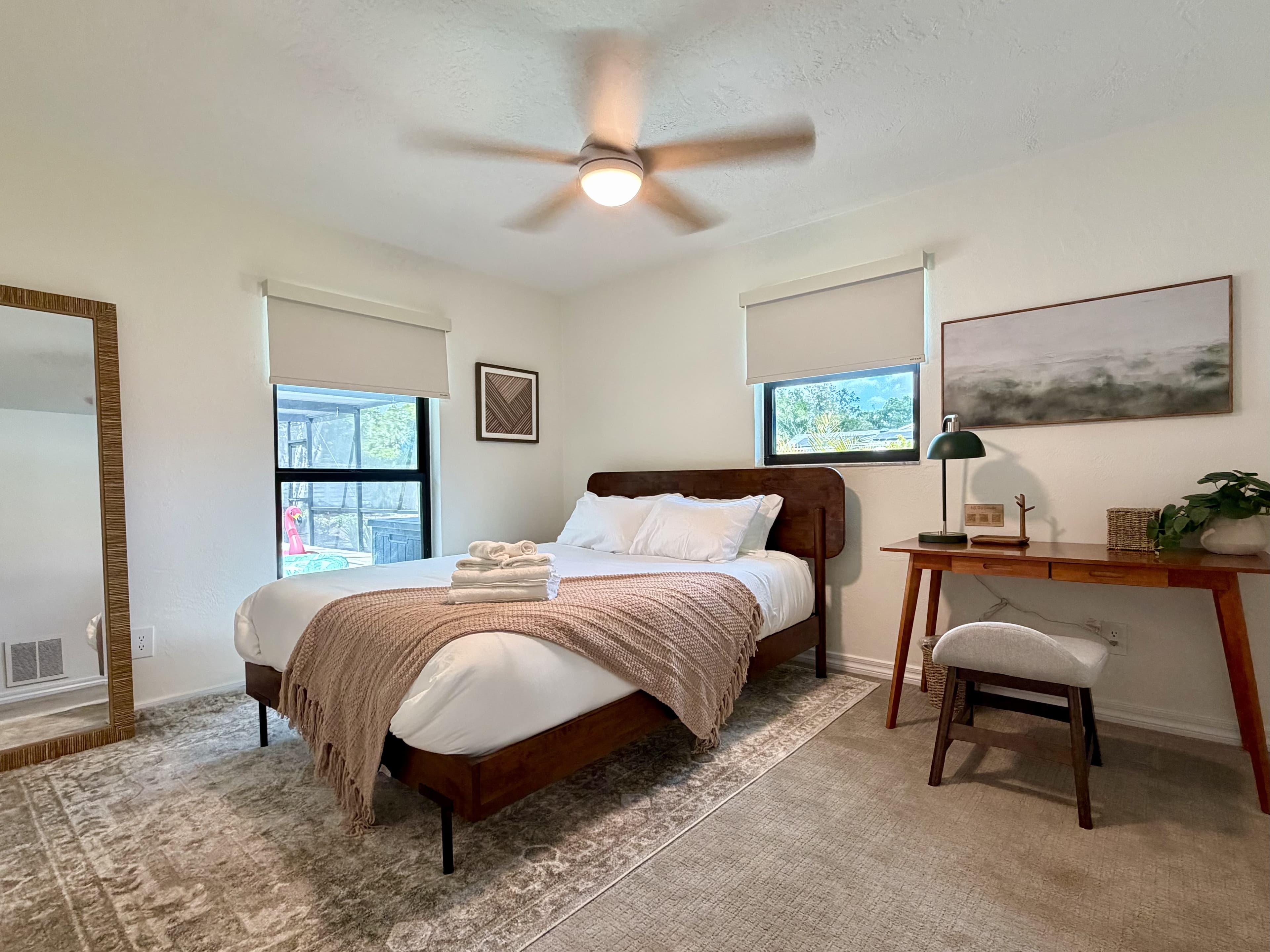 Drift Shore bedroom with writing desk, ceiling fan and full-length mirror