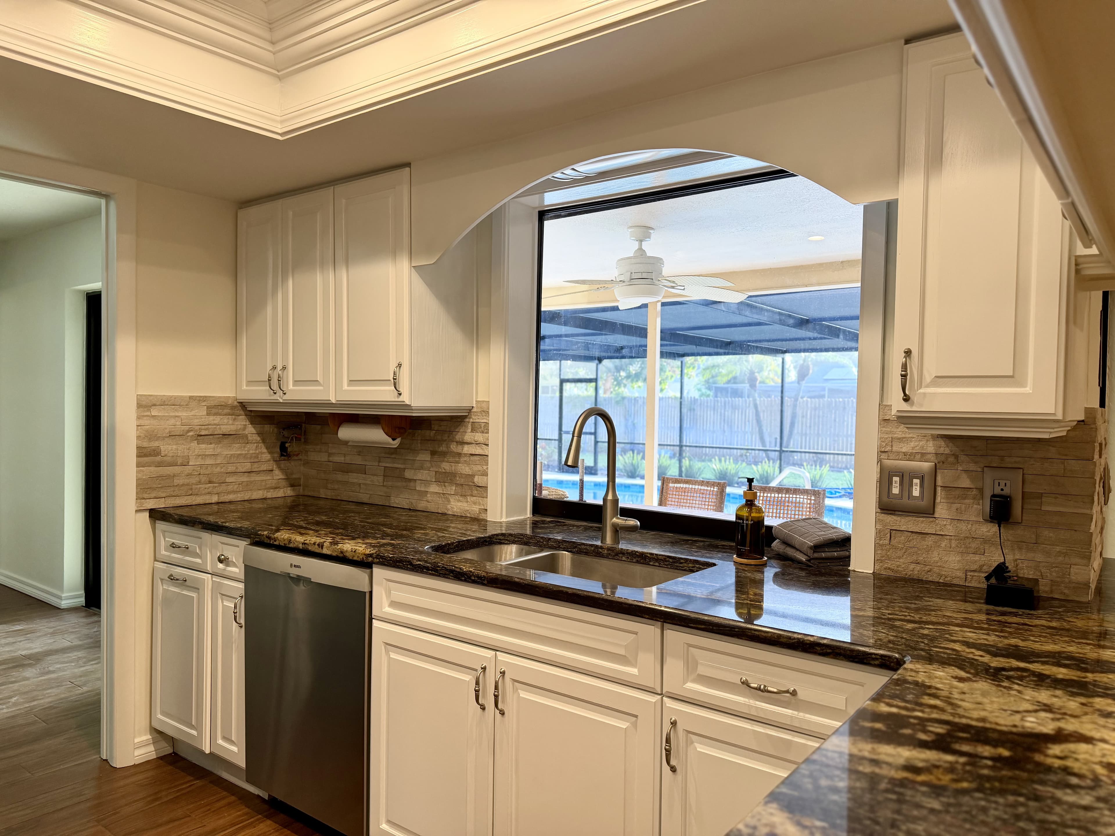 kitchen with granite counters and lanai view