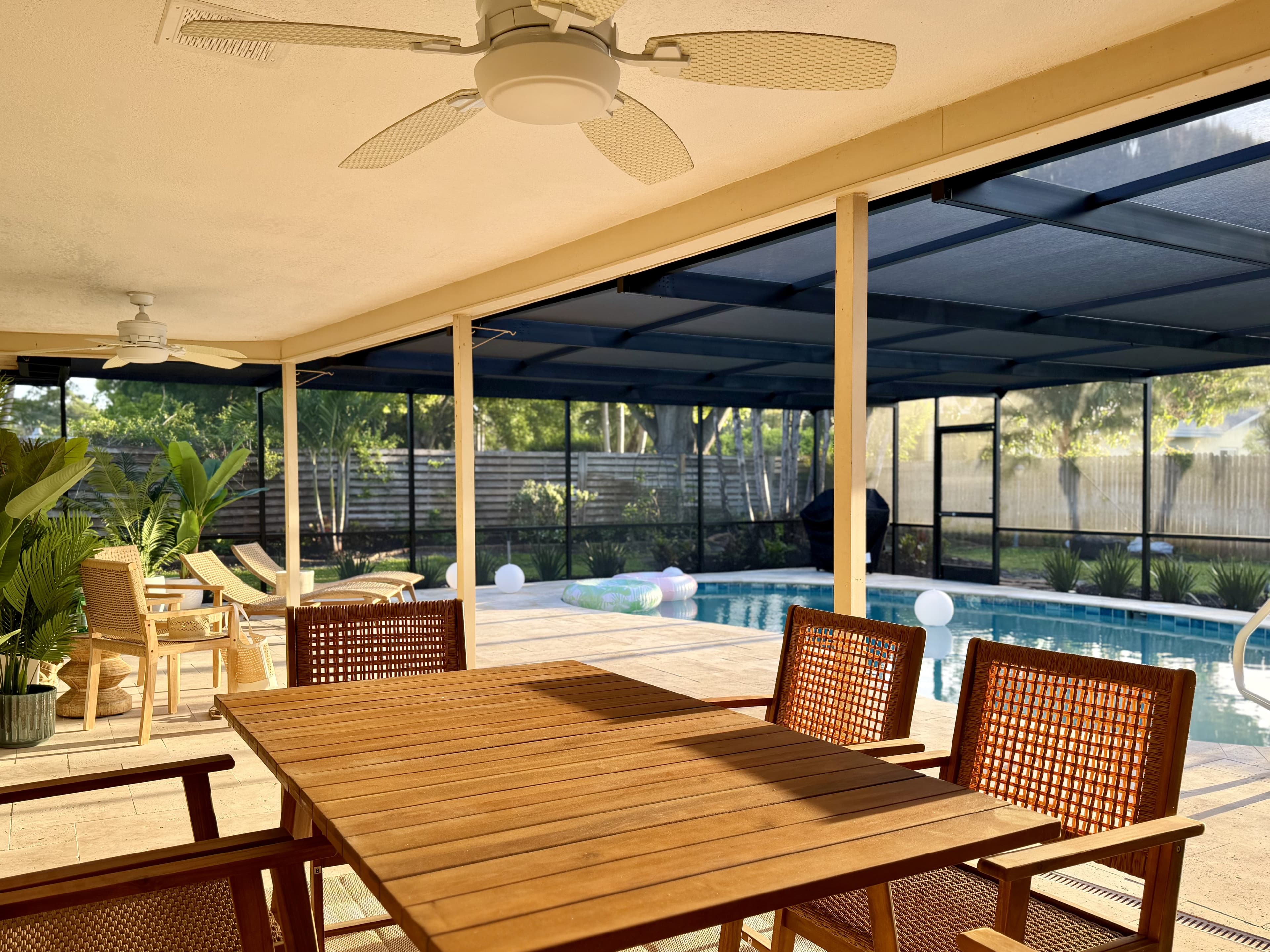 Lanai dining with pool view at dusk