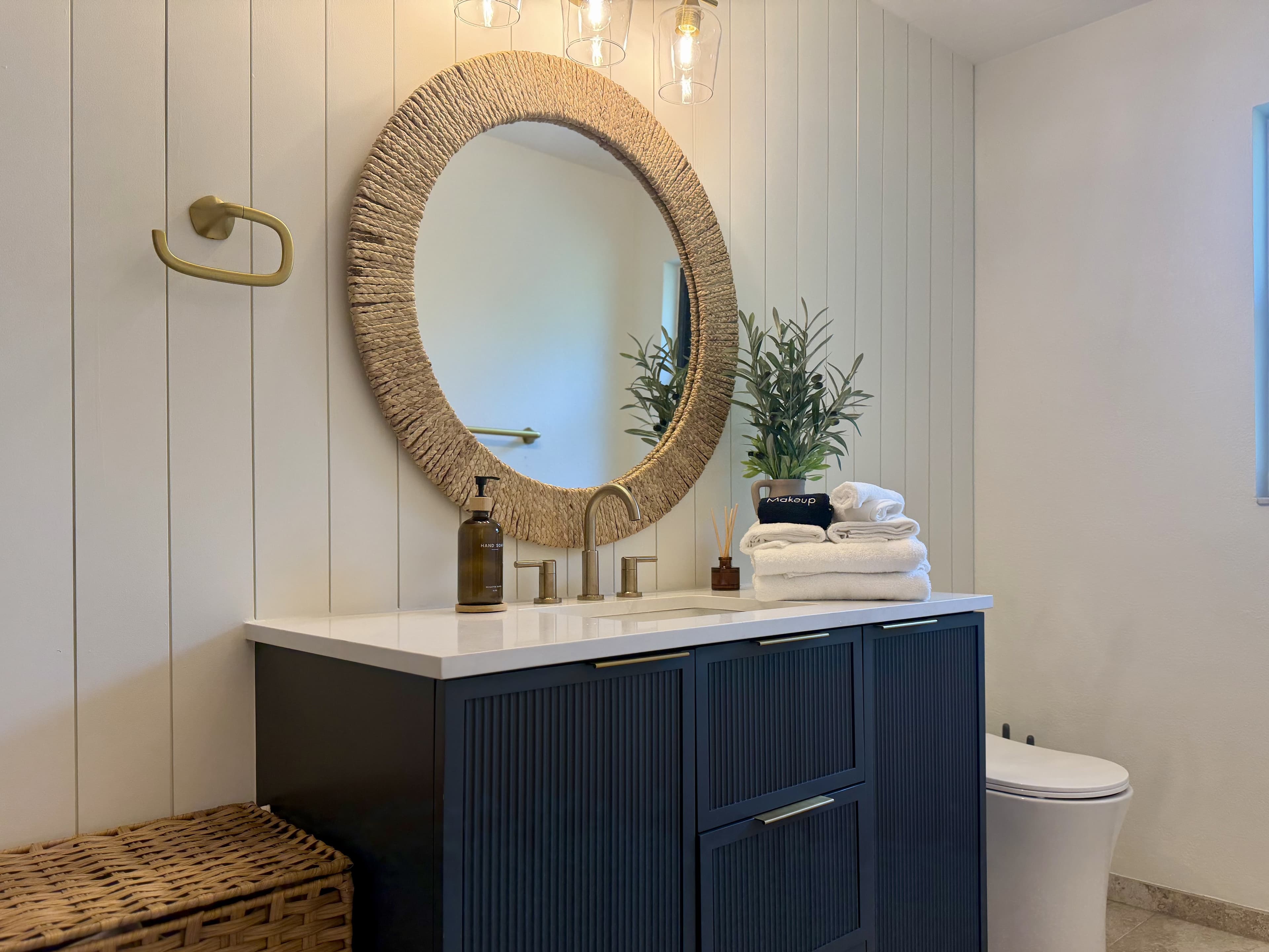 Coastal-inspired bathroom with navy vanity