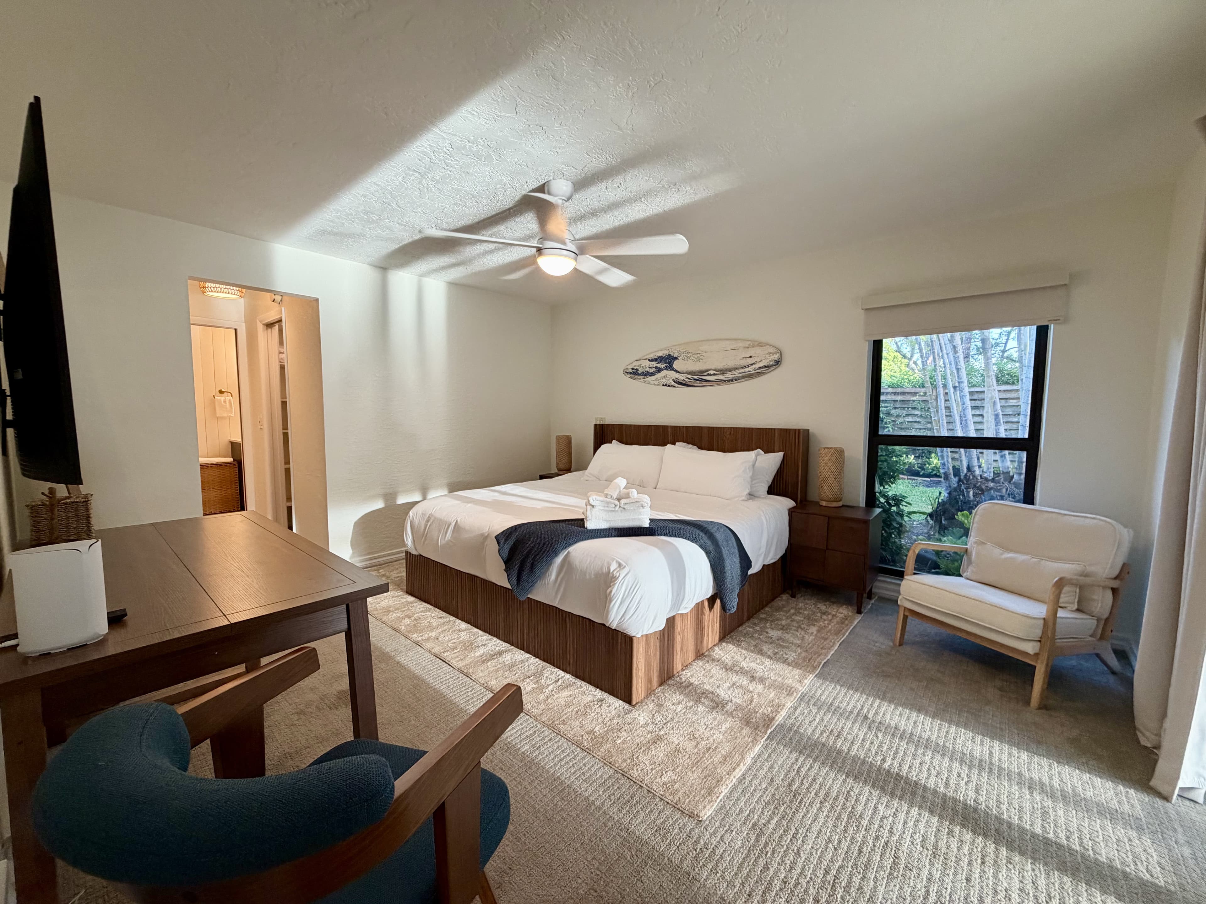 surf suite with walnut furnishings and garden view